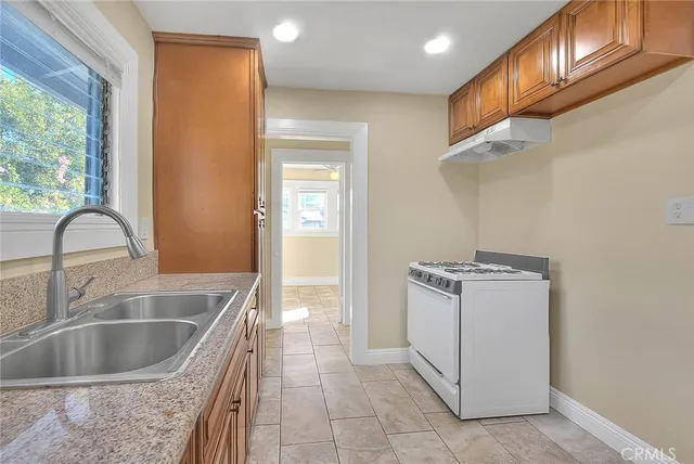 a kitchen with granite countertop cabinets and window