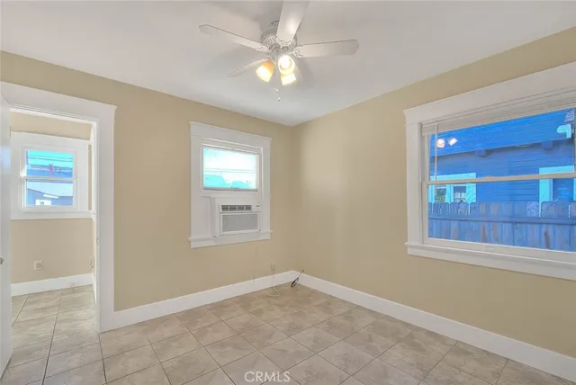 an empty room with closet and a ceiling fan