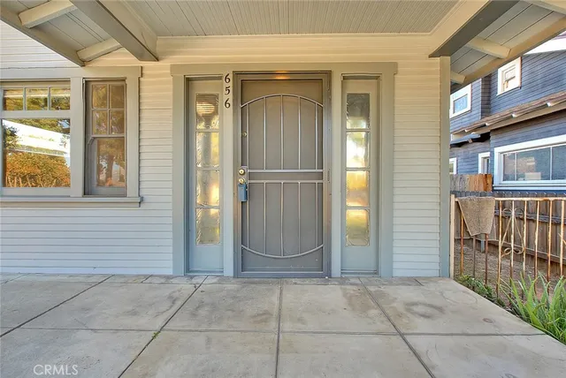 a view of a pathway of a house with potted plants