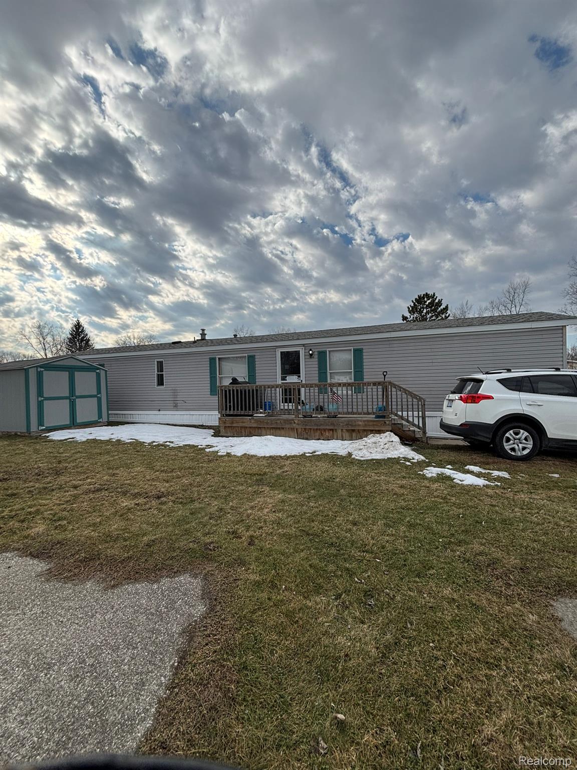 246 South Sheridan Road Lennon, MI 48449 - Photo 2 of 12 Manufactured / mobile home with a storage shed, a front yard, and a deck