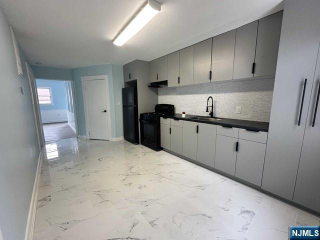 a kitchen with granite countertop a sink and cabinets