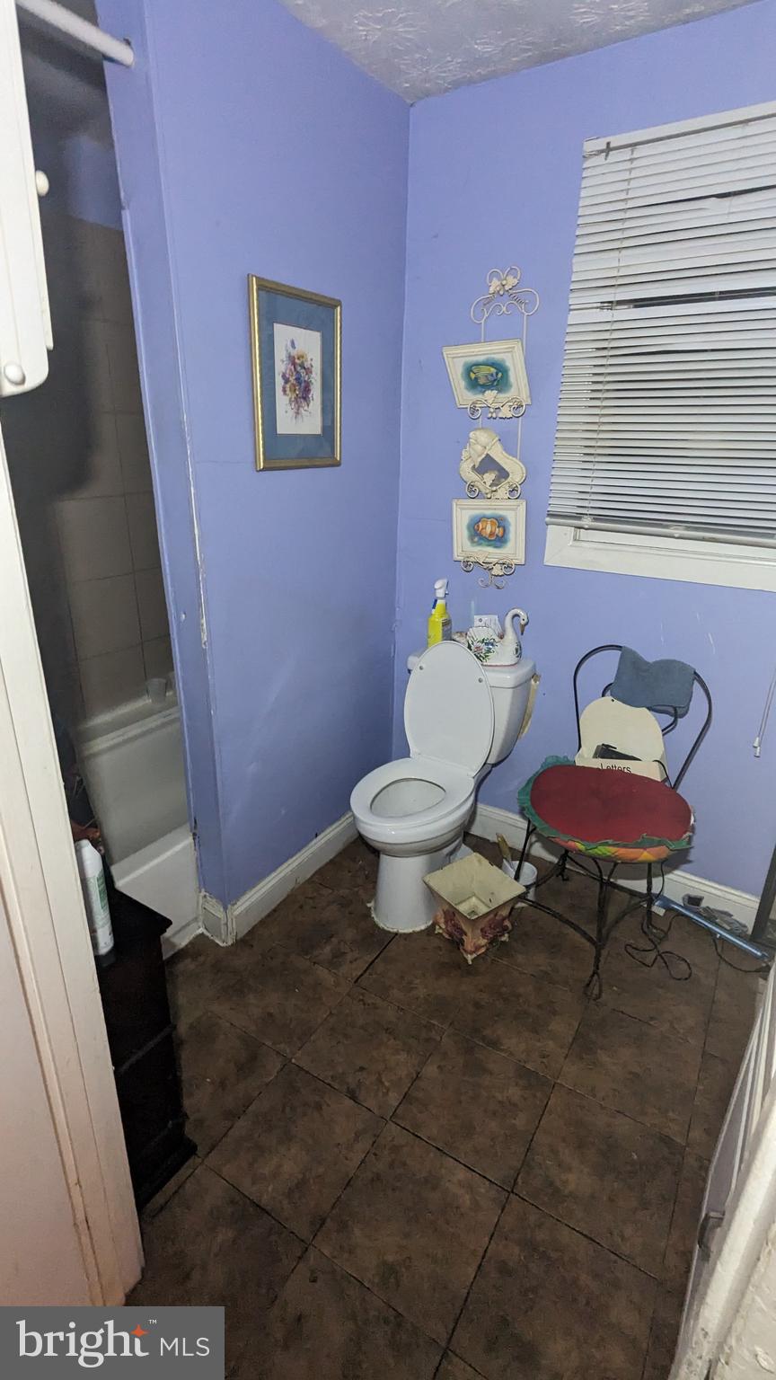 6740 Solomons Island Road North Owings, MD 20736 - Photo 18 of 58 a bathroom with a toilet a sink and a mirror
