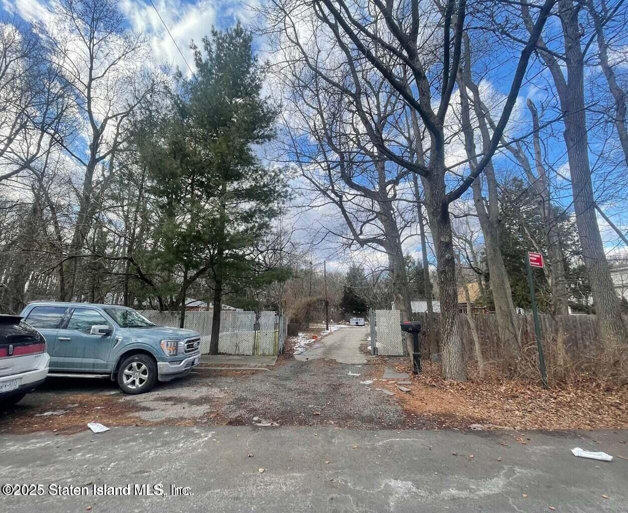 75 79/83 Halpin Avenue Staten Island, NY 10312 - Photo 6 of 7 a view of a yard with a car parked on the side of it