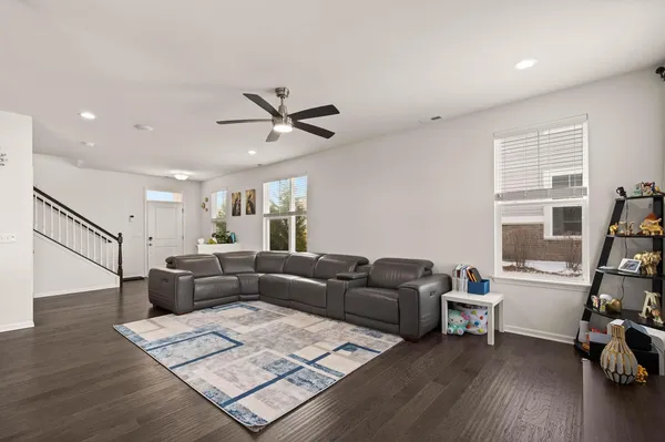 a living room with furniture and wooden floor