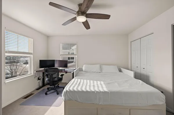 a bedroom with a bed window and furniture