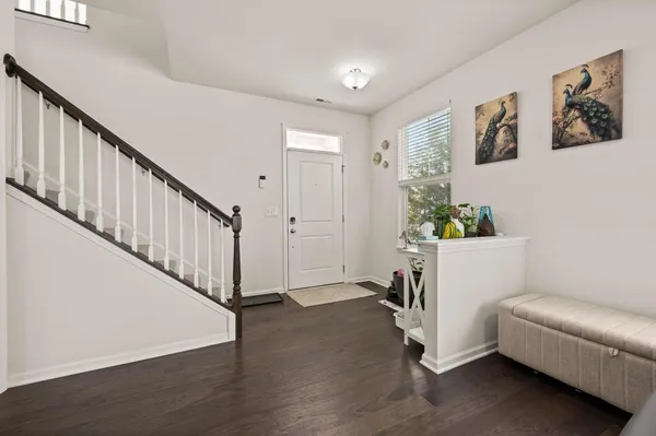 a view of a hallway with workspace and a window