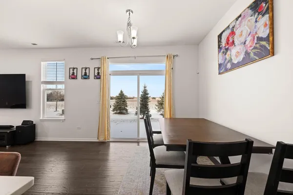 a view of a dining room with furniture wooden floor and a flat screen tv