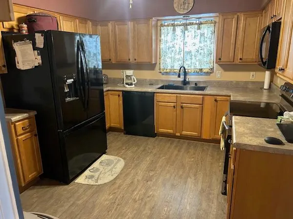a kitchen with a refrigerator and a sink