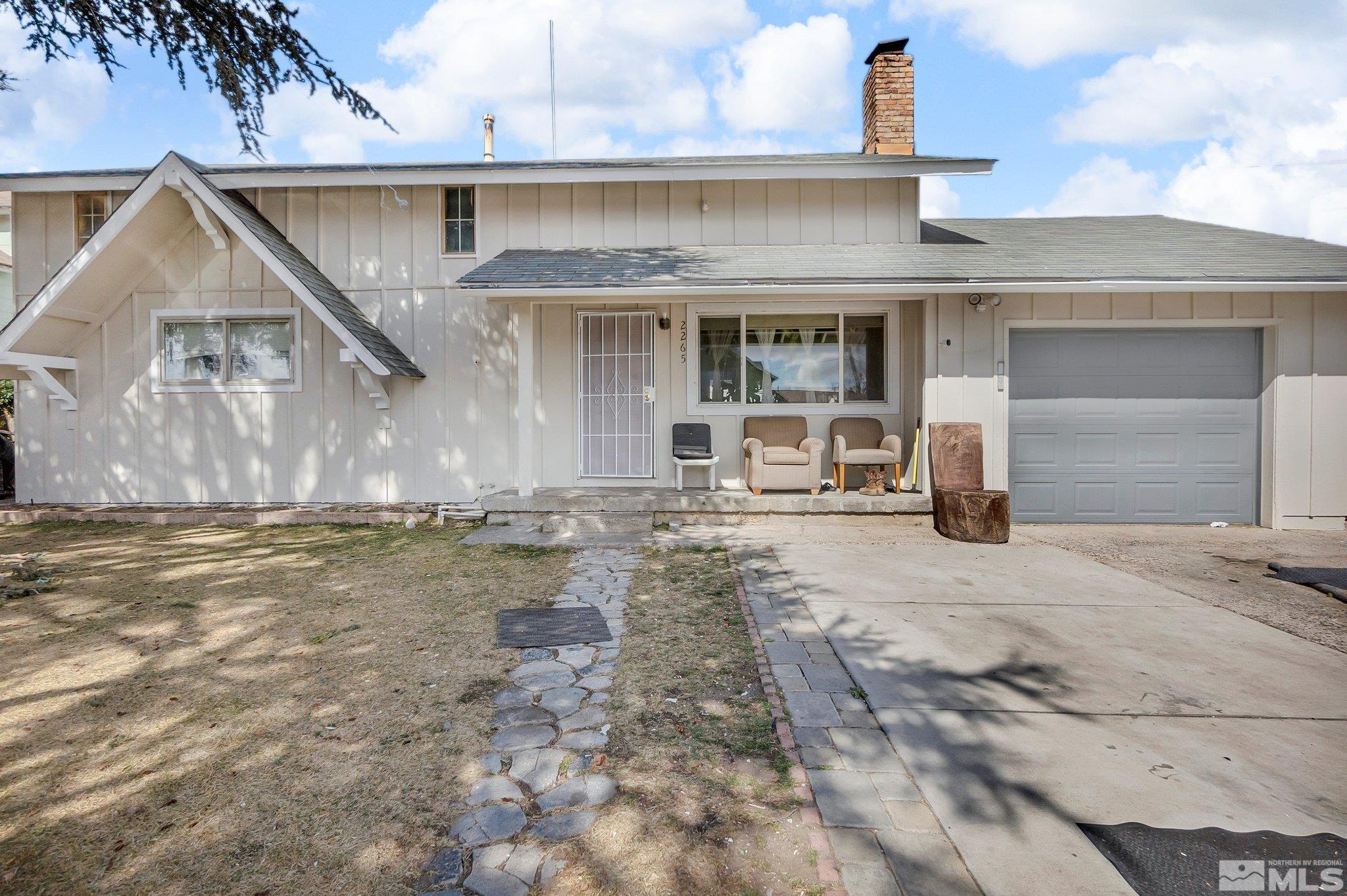 2265 Mannington Street Reno, NV 89512 - Photo 1 of 25 a front view of a house with a yard and garage