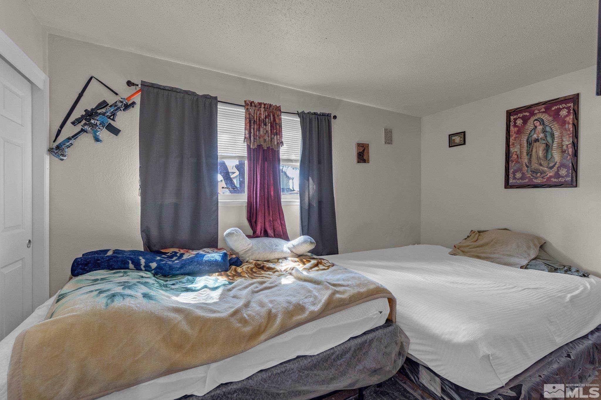 2265 Mannington Street Reno, NV 89512 - Photo 12 of 25 a bedroom with a bed and a window