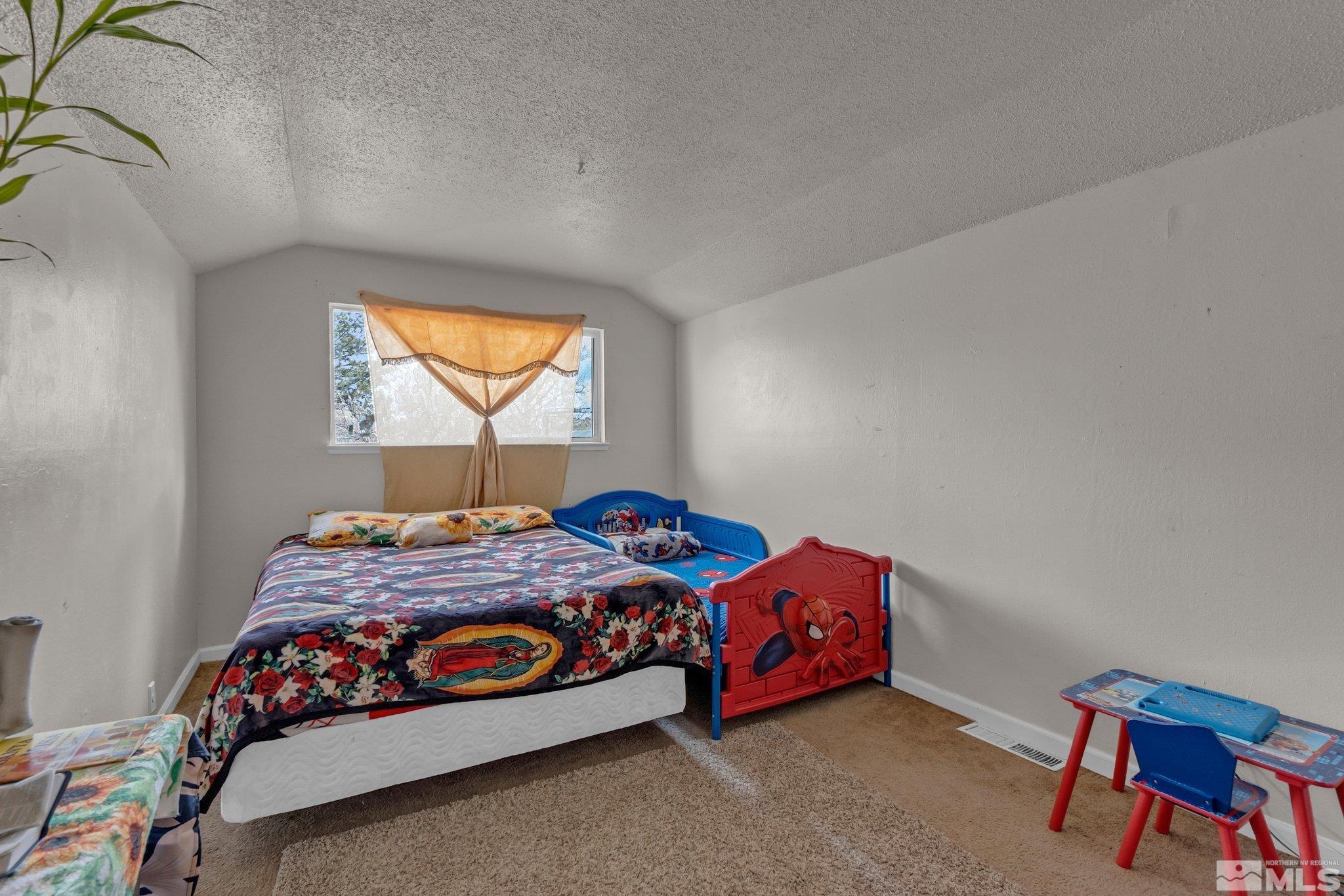 2265 Mannington Street Reno, NV 89512 - Photo 15 of 25 a bedroom with a bed and window