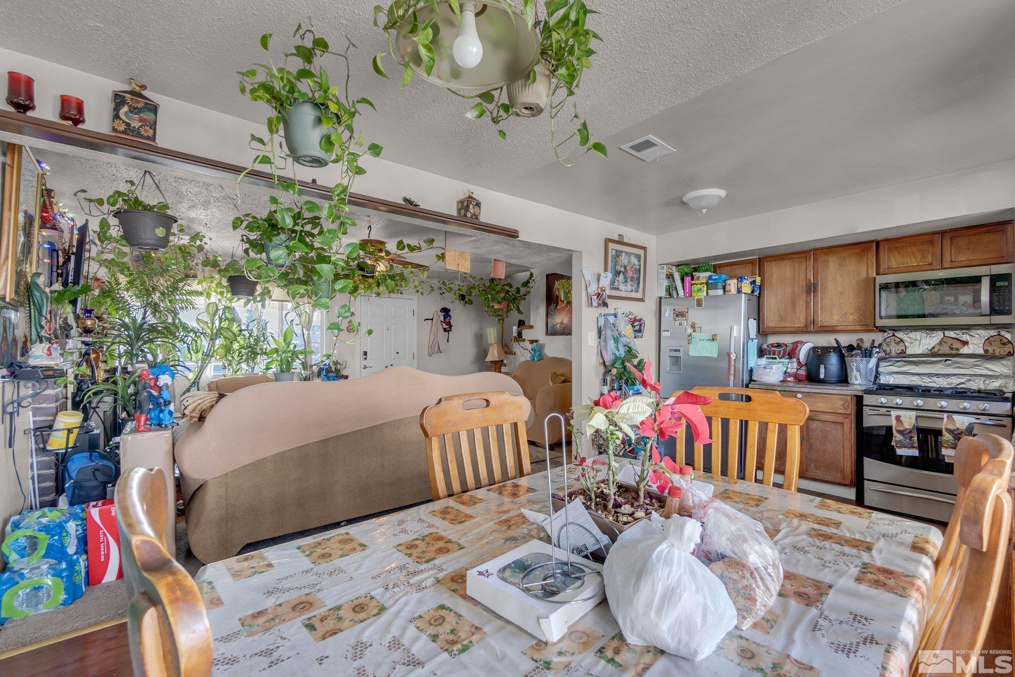 2265 Mannington Street Reno, NV 89512 - Photo 6 of 25 a bedroom with bed and a potted plant