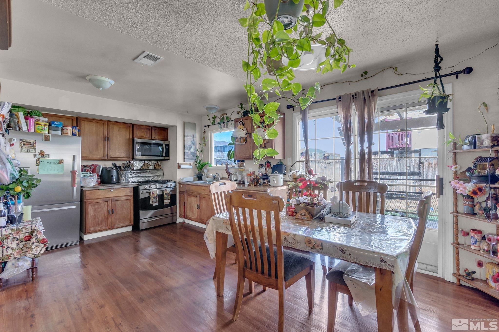 2265 Mannington Street Reno, NV 89512 - Photo 7 of 25 a view of a dining room with furniture window and wooden floor