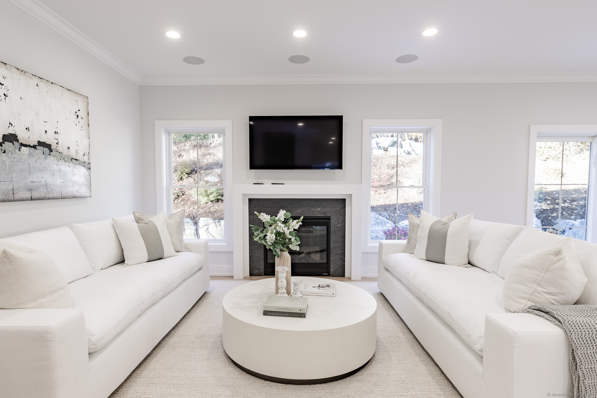 3 Pine Ridge, Unit 23 Middlebury, CT 06762 - Photo 8 of 28 a living room with furniture a fireplace and a flat screen tv