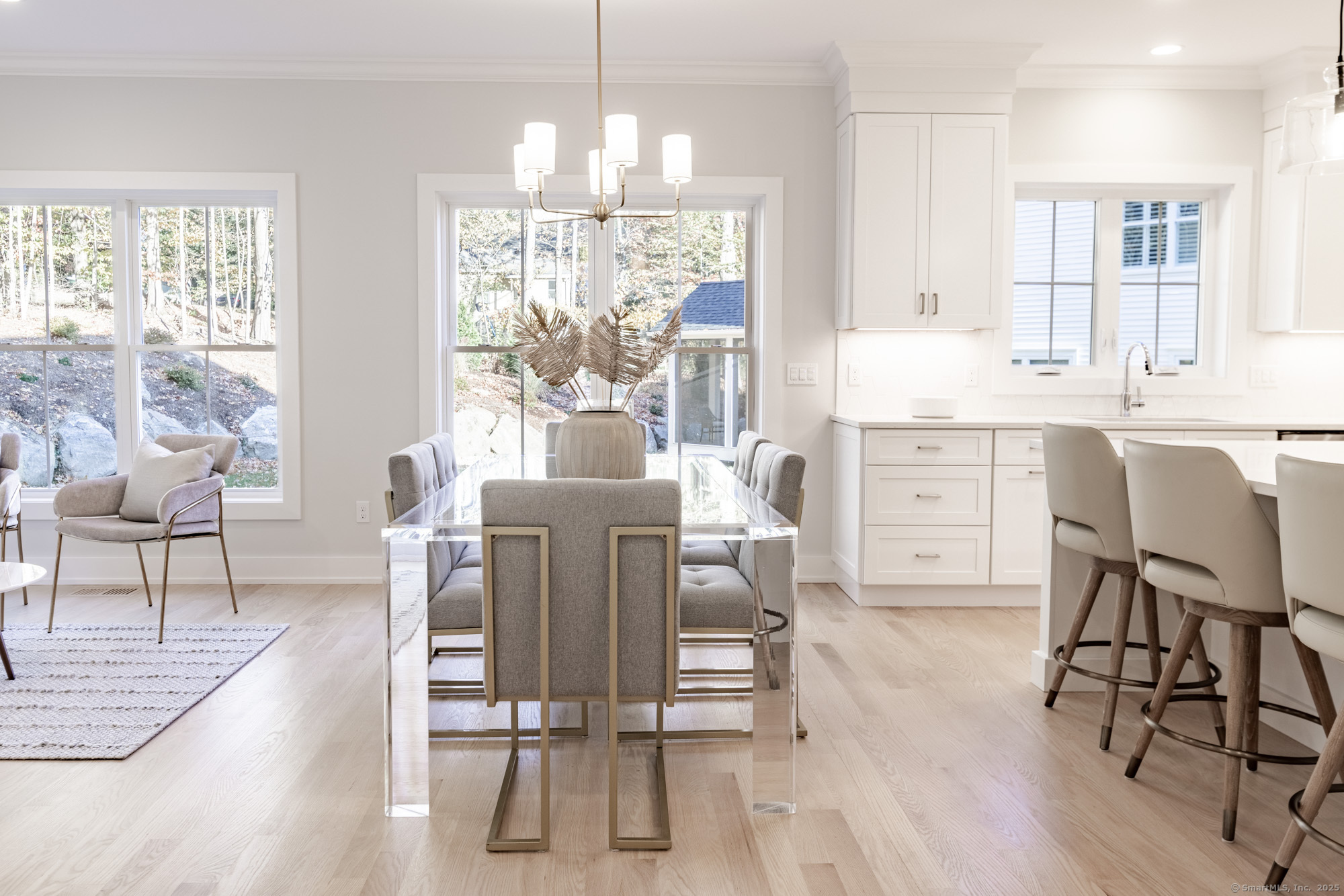 3 Pine Ridge, Unit 23 Middlebury, CT 06762 - Photo 9 of 28 a dining room filled chandelier and wooden floor