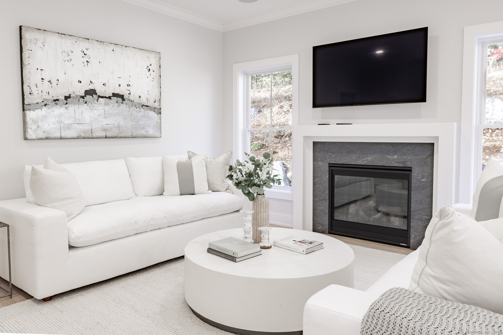 3 Pine Ridge, Unit 23 Middlebury, CT 06762 - Photo 10 of 28 a living room with furniture a flat screen tv and a fireplace