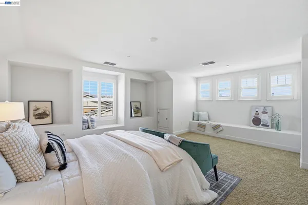 an aerial view of residential houses with outdoor space and ocean view
