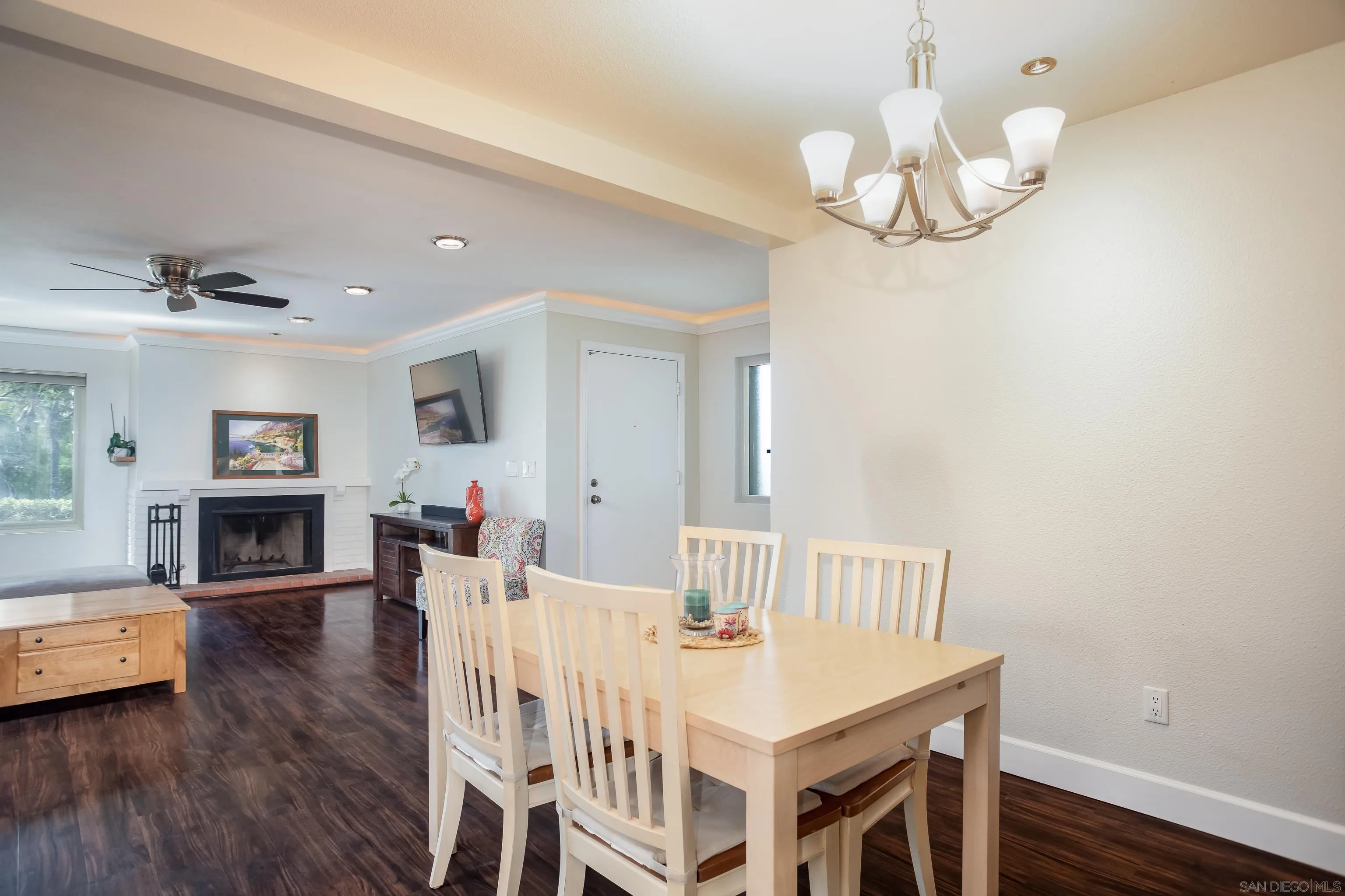 6345 Rancho Mission Road, Unit 3 San Diego, CA 92108 - Photo 11 of 43 a view of a dining room with furniture a chandelier and wooden floor