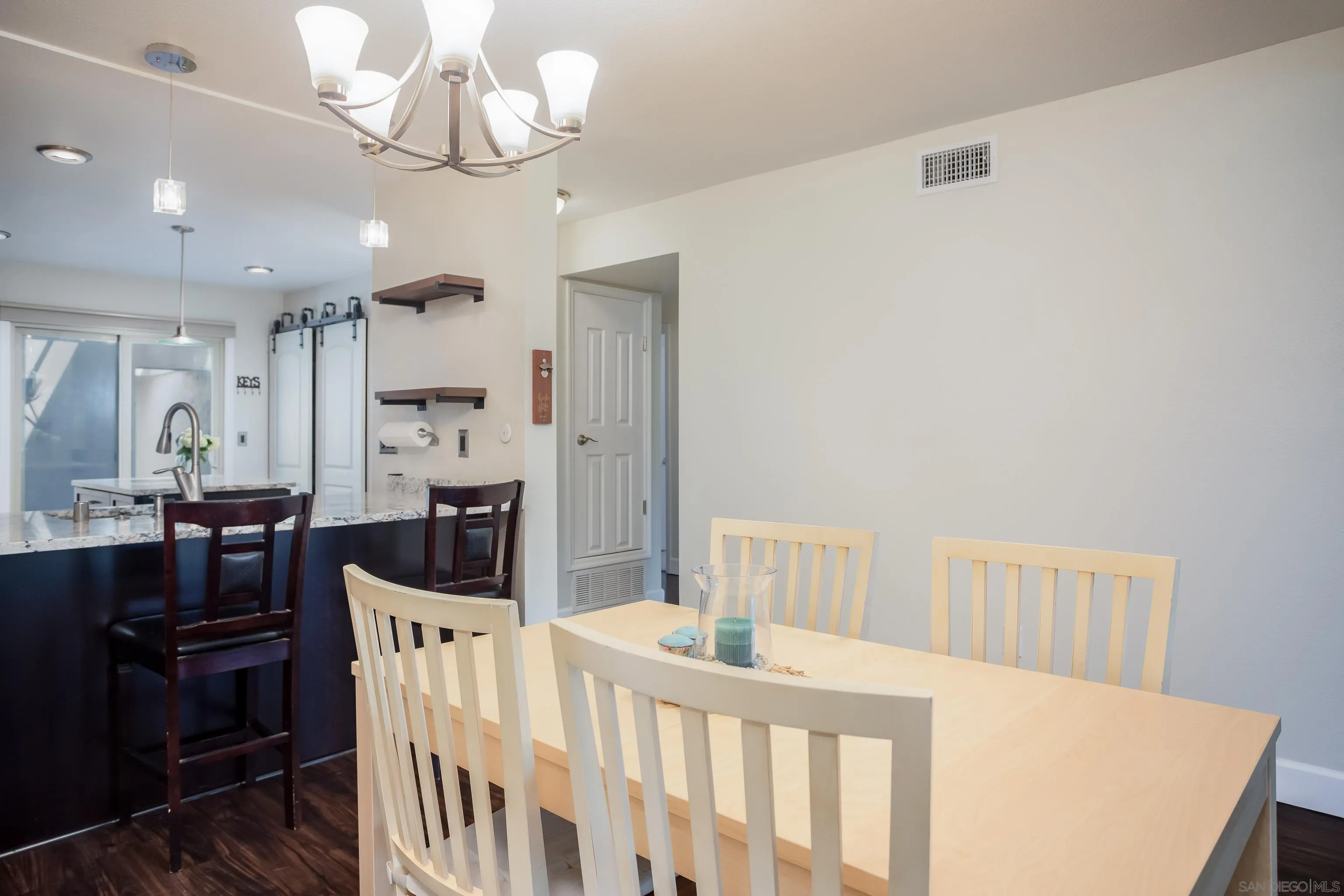 6345 Rancho Mission Road, Unit 3 San Diego, CA 92108 - Photo 12 of 43 a bedroom with furniture and a chandelier