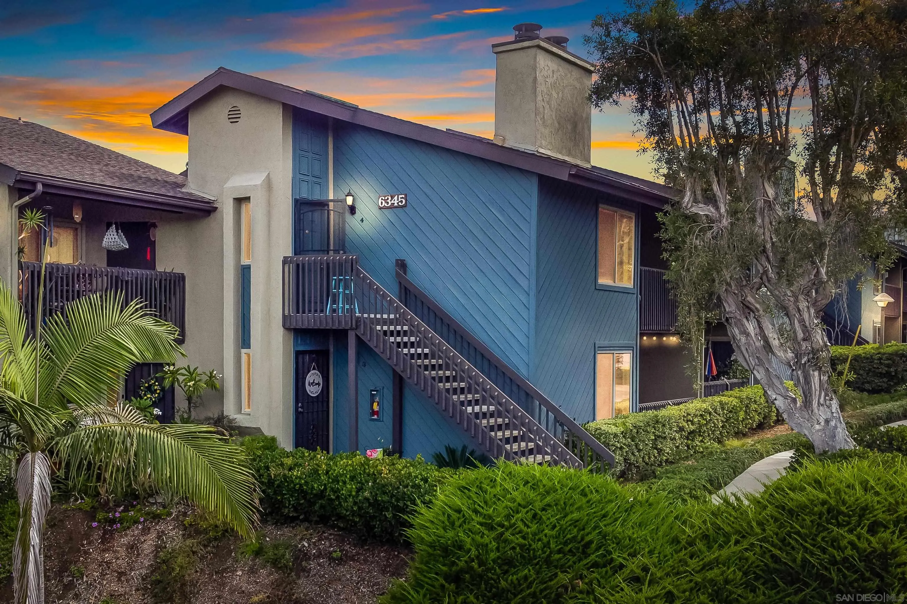 6345 Rancho Mission Road, Unit 3 San Diego, CA 92108 - Photo 2 of 43 a view of a house with wooden fence and potted plants