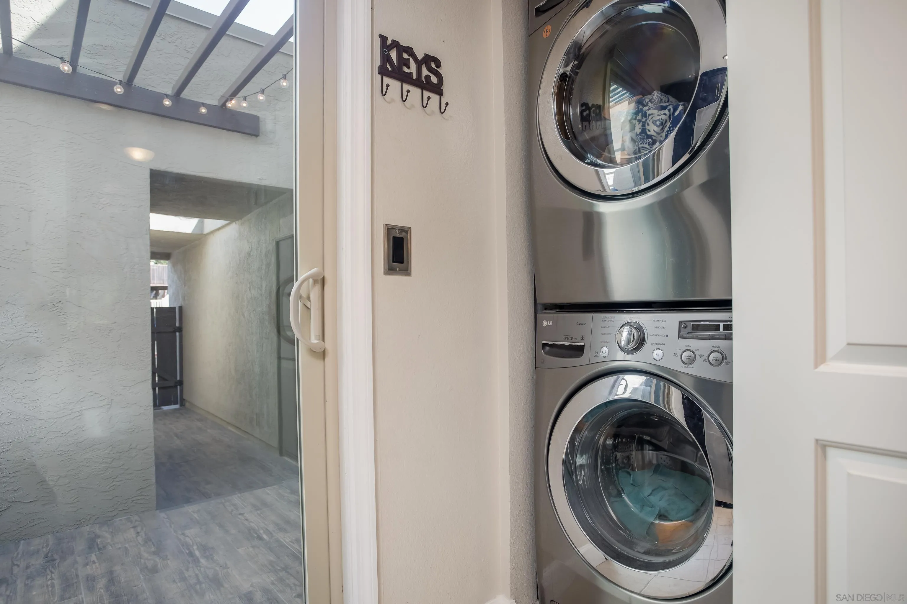6345 Rancho Mission Road, Unit 3 San Diego, CA 92108 - Photo 31 of 43 a view of a hallway with washer and dryer