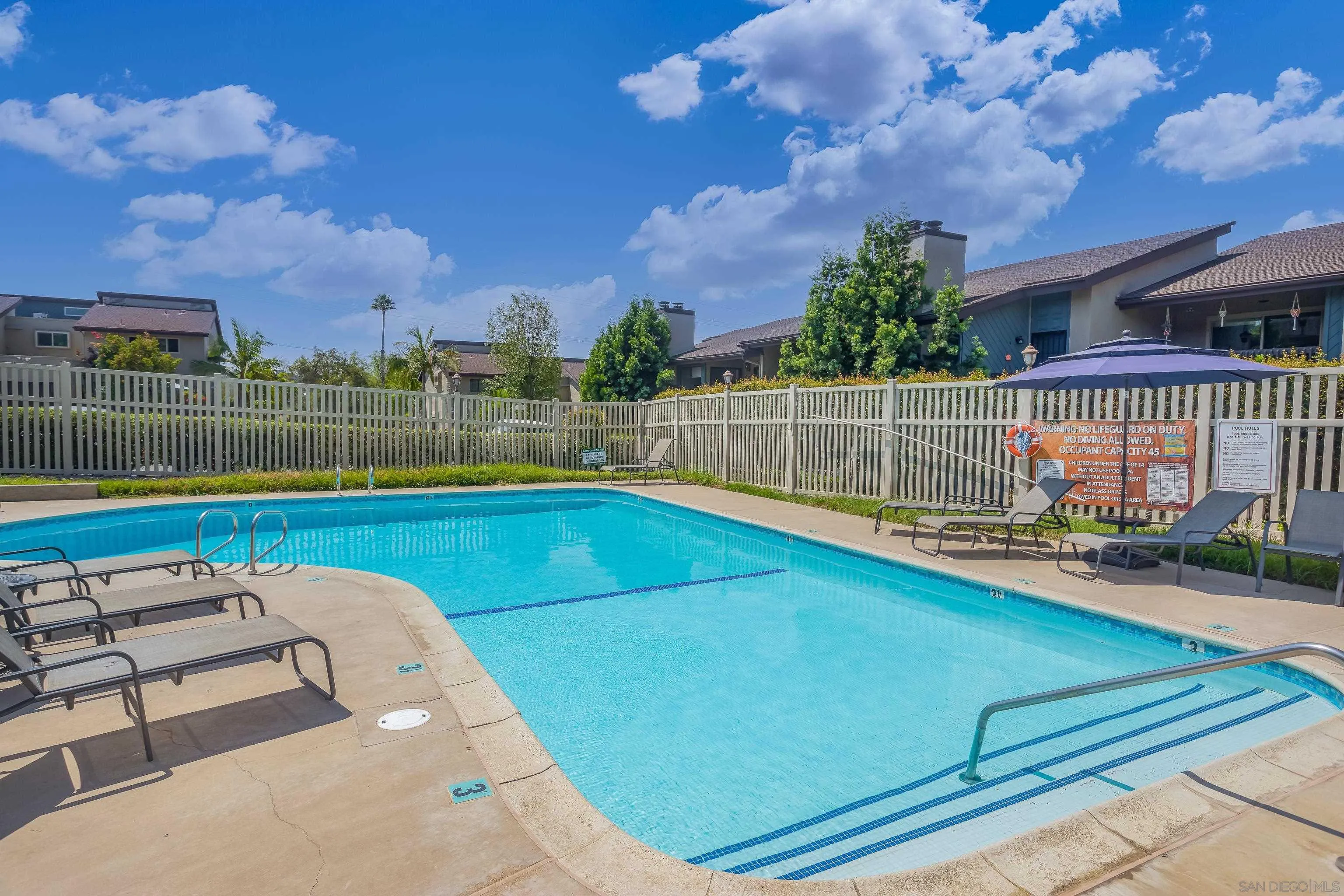 6345 Rancho Mission Road, Unit 3 San Diego, CA 92108 - Photo 39 of 43 a view of a swimming pool with a patio and a yard