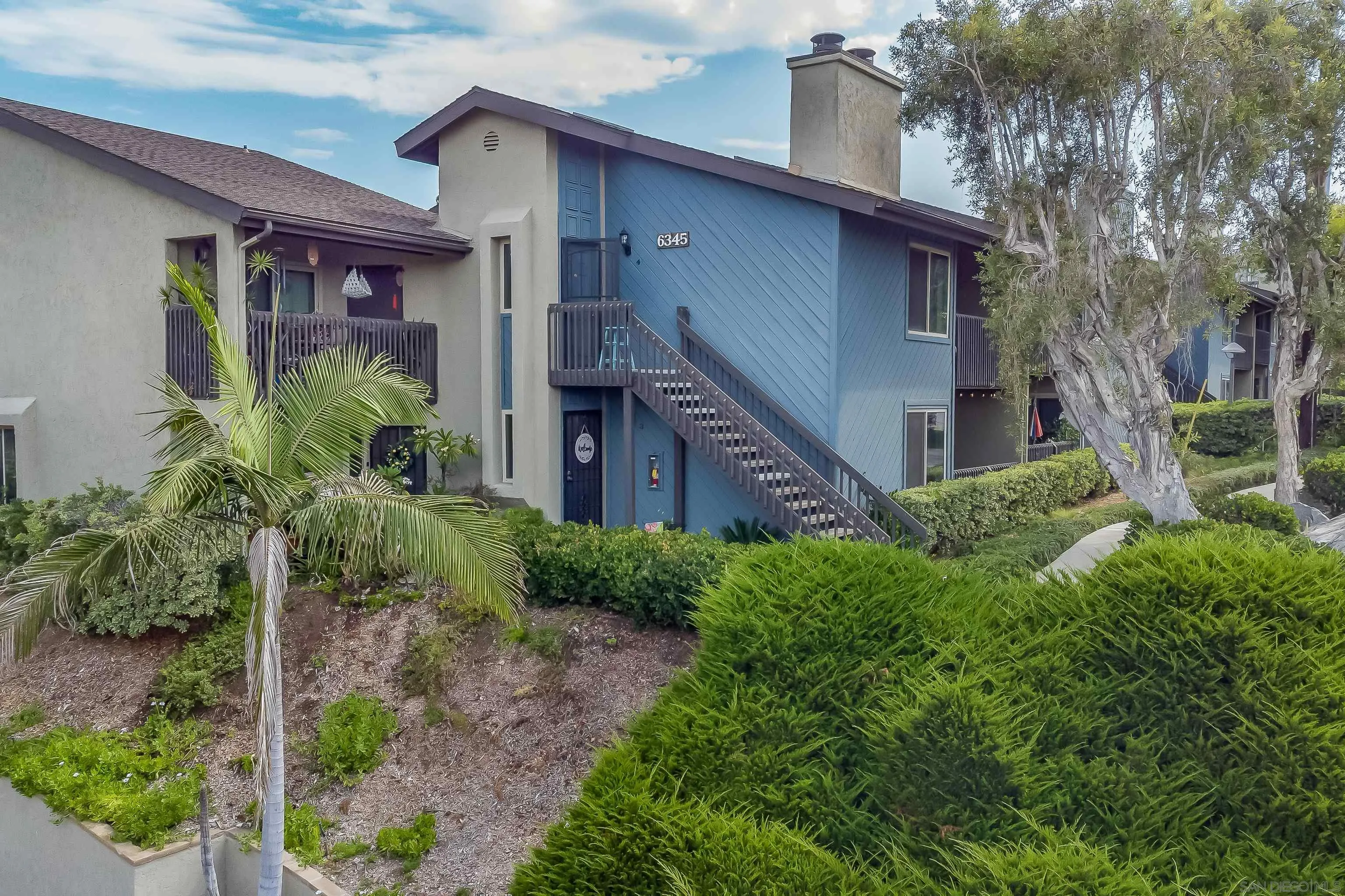 6345 Rancho Mission Road, Unit 3 San Diego, CA 92108 - Photo 6 of 43 a front view of a house with garden