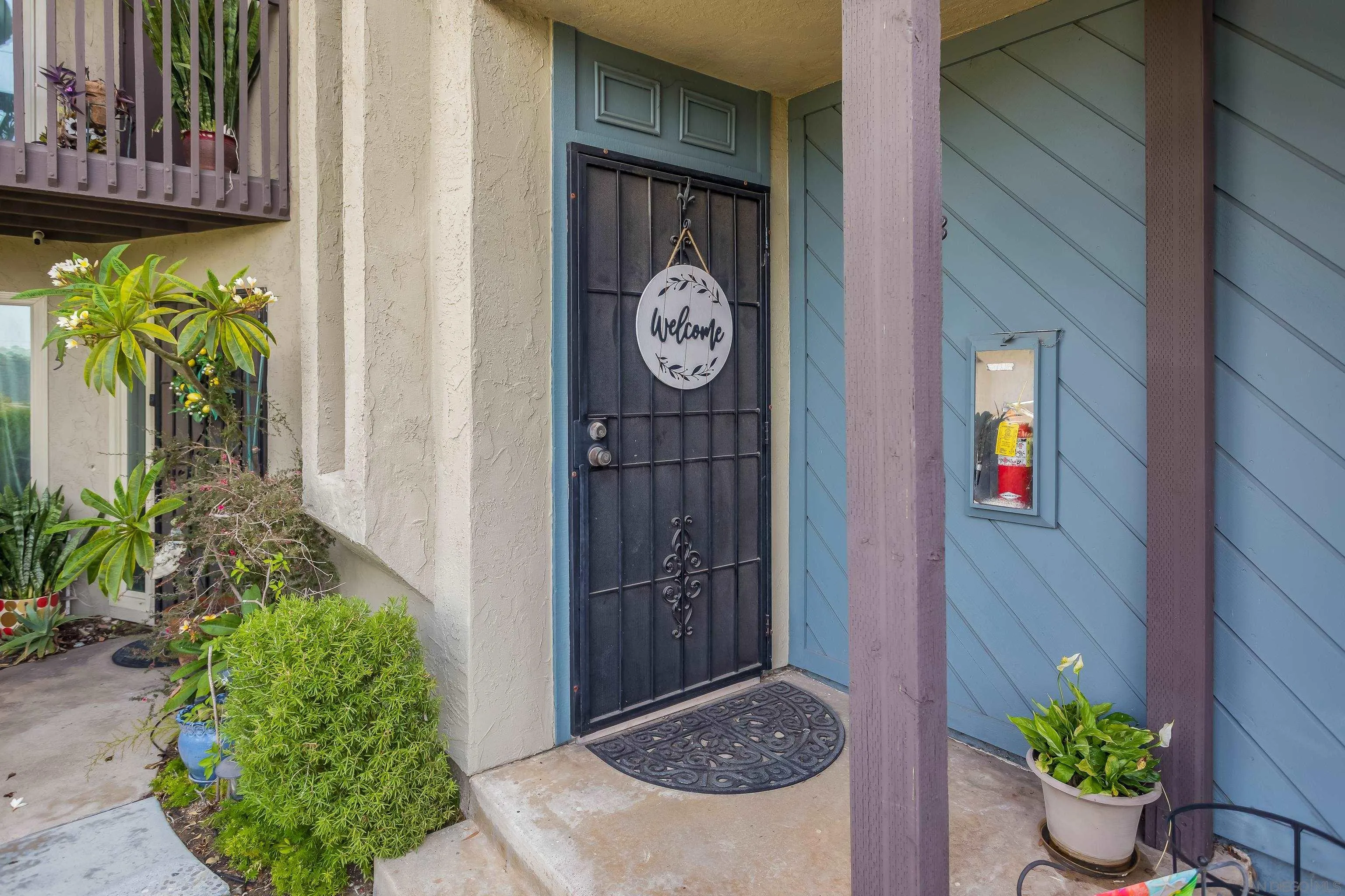 6345 Rancho Mission Road, Unit 3 San Diego, CA 92108 - Photo 7 of 43 a view of an entryway of a house with potted plants