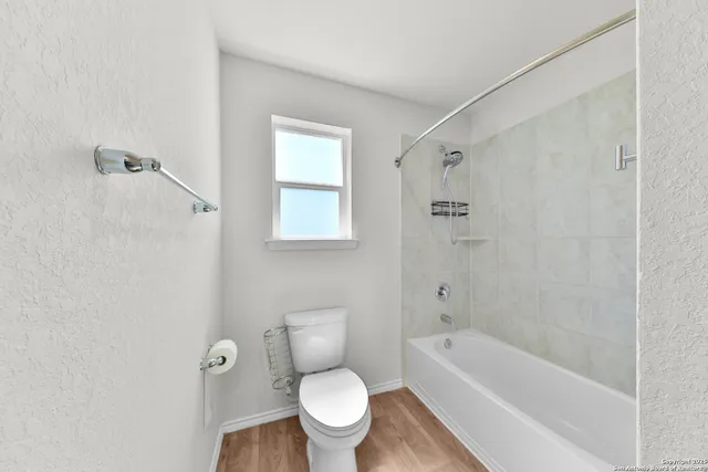 a bathroom with a toilet sink and shower