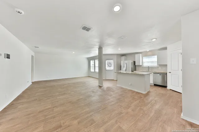 a view of a kitchen with a sink and cabinets