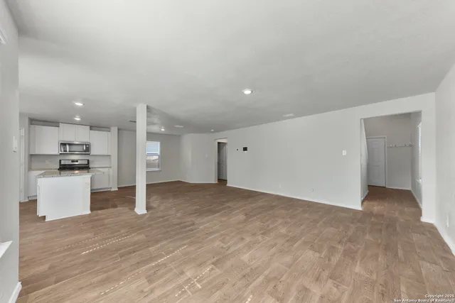 a view of a kitchen with a sink and a refrigerator