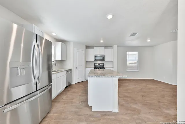 a kitchen with stainless steel appliances a refrigerator and a sink