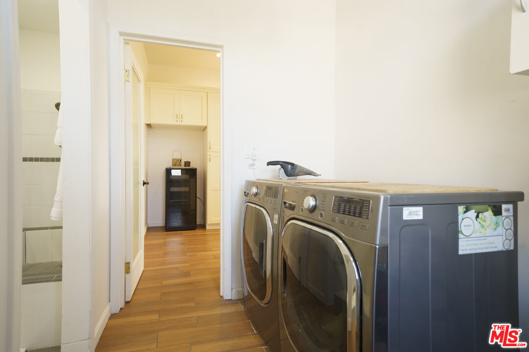 1159 South Norton Avenue Los Angeles, CA 90019 - Photo 21 of 39 a view of a hallway with washer and dryer