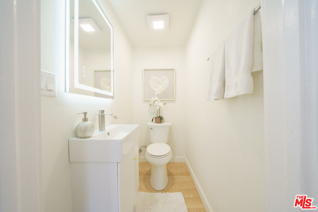 1159 South Norton Avenue Los Angeles, CA 90019 - Photo 24 of 39 a bathroom with a sink toilet and a mirror