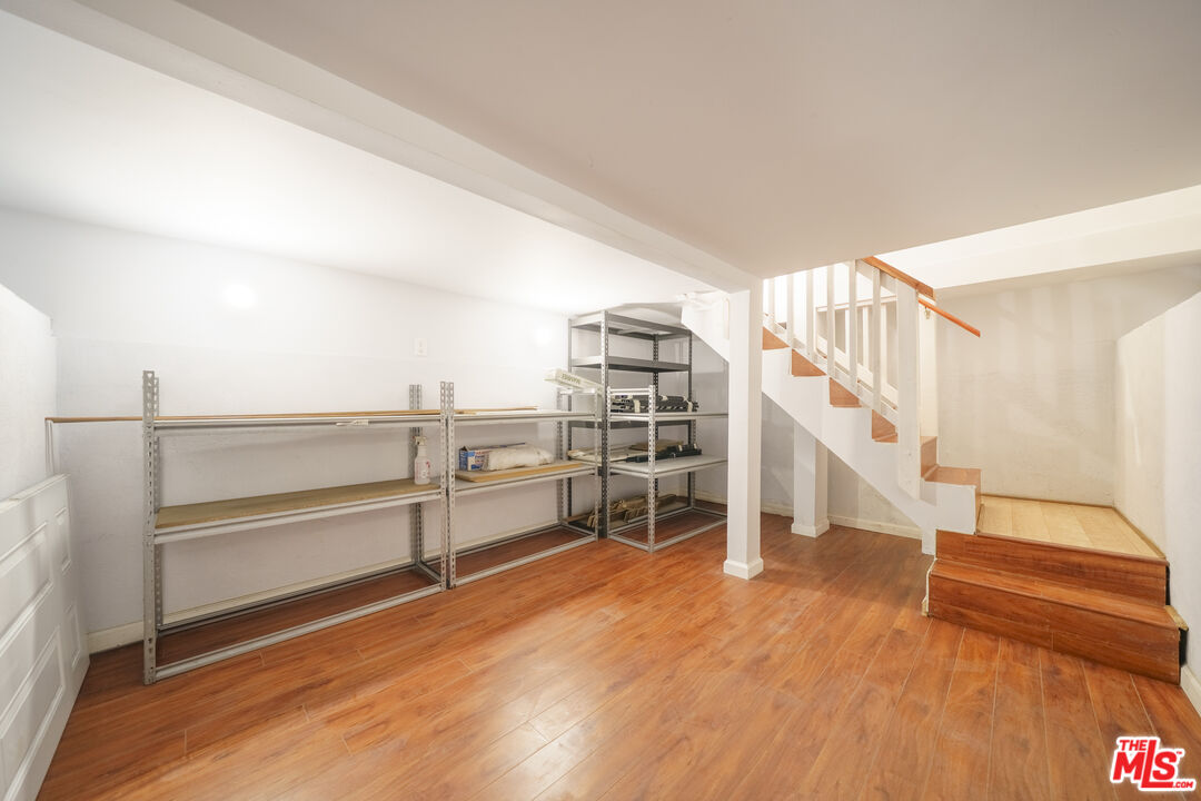 1159 South Norton Avenue Los Angeles, CA 90019 - Photo 26 of 39 a view of a room with racks on the wall