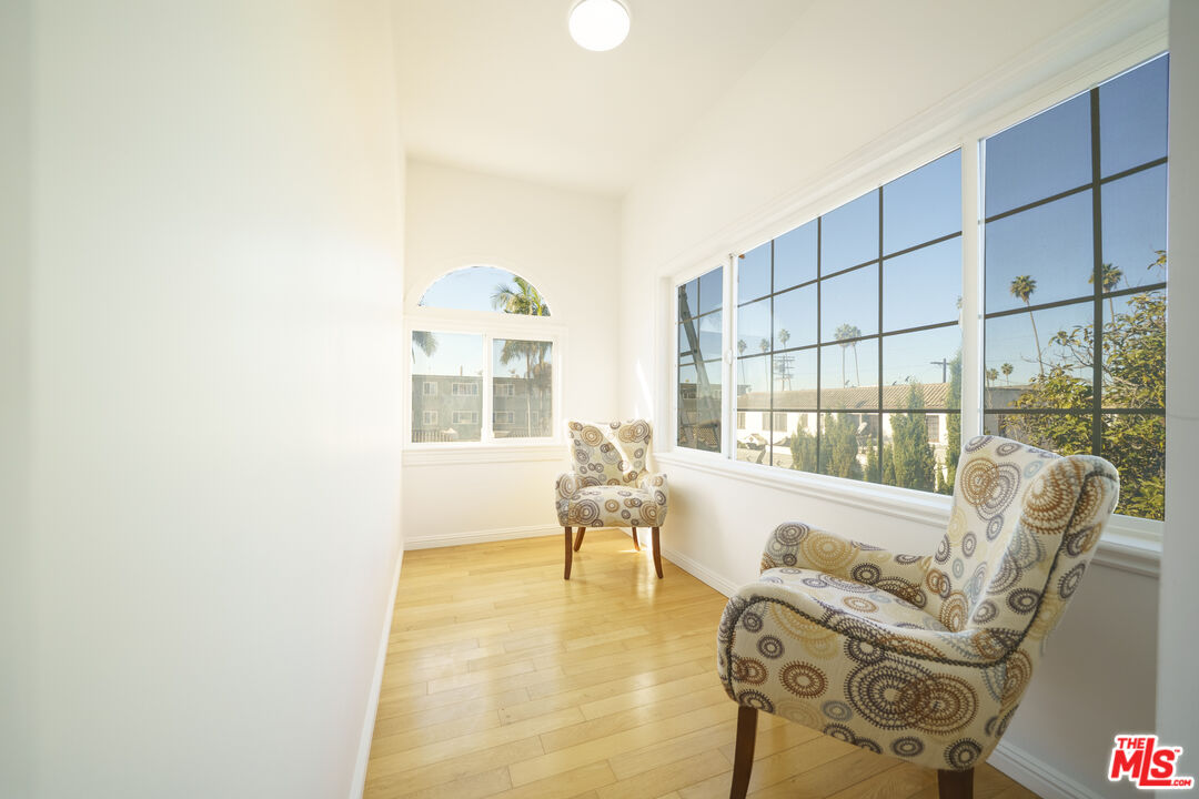 1159 South Norton Avenue Los Angeles, CA 90019 - Photo 37 of 39 a living room with furniture and a floor to ceiling window