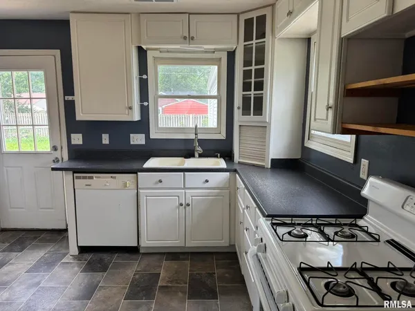 a kitchen with appliances cabinets and a window