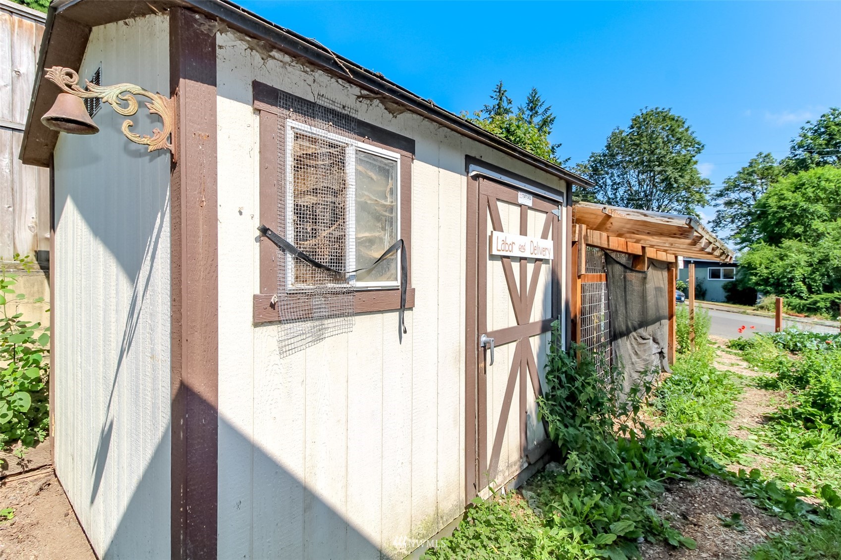12011 Southeast 157th Place Renton, WA 98058 - Photo 23 of 40 a view of a house with a small yard and floor to ceiling window and wooden fence