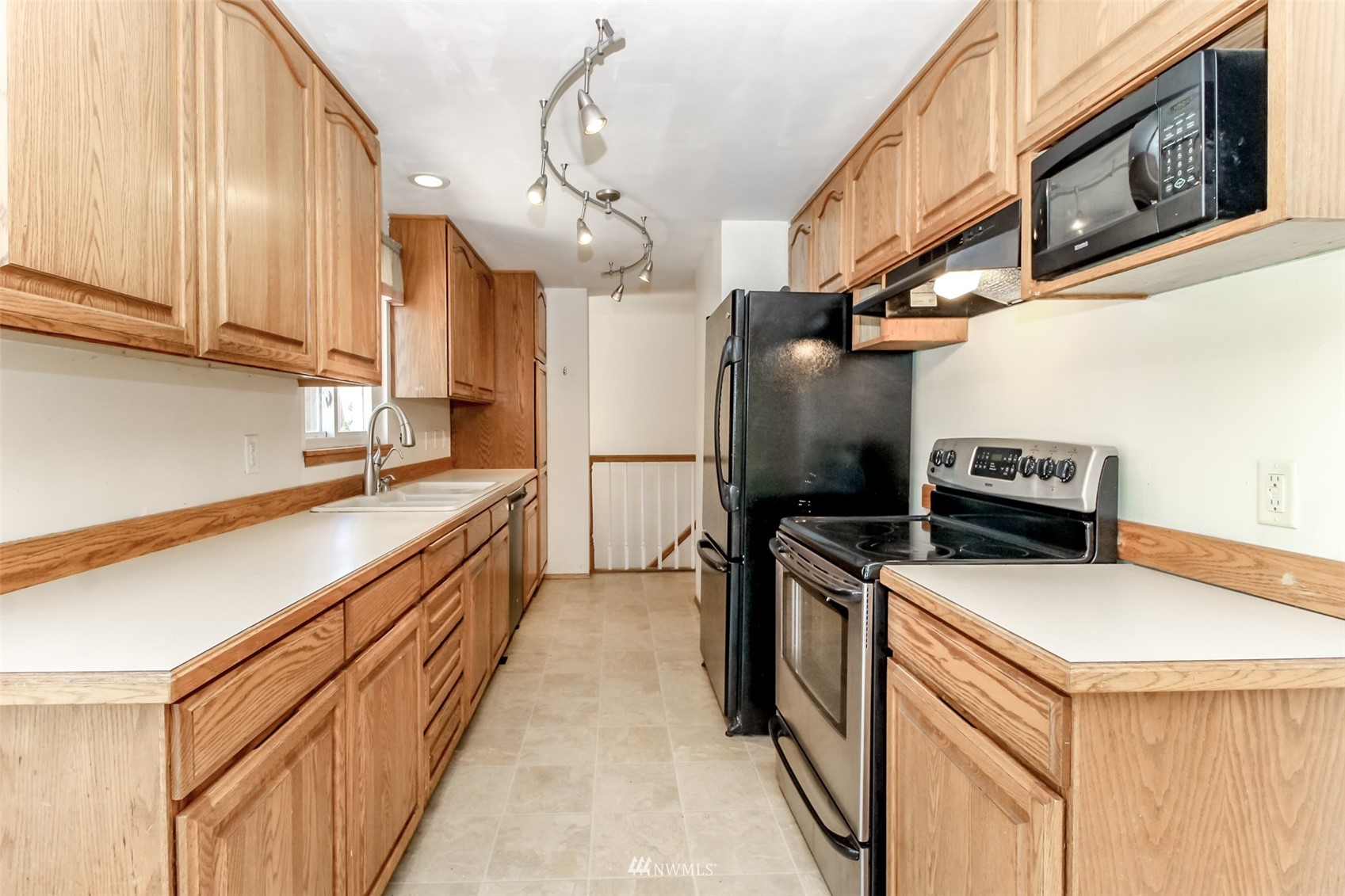 12011 Southeast 157th Place Renton, WA 98058 - Photo 28 of 40 a kitchen that has a sink and a stove