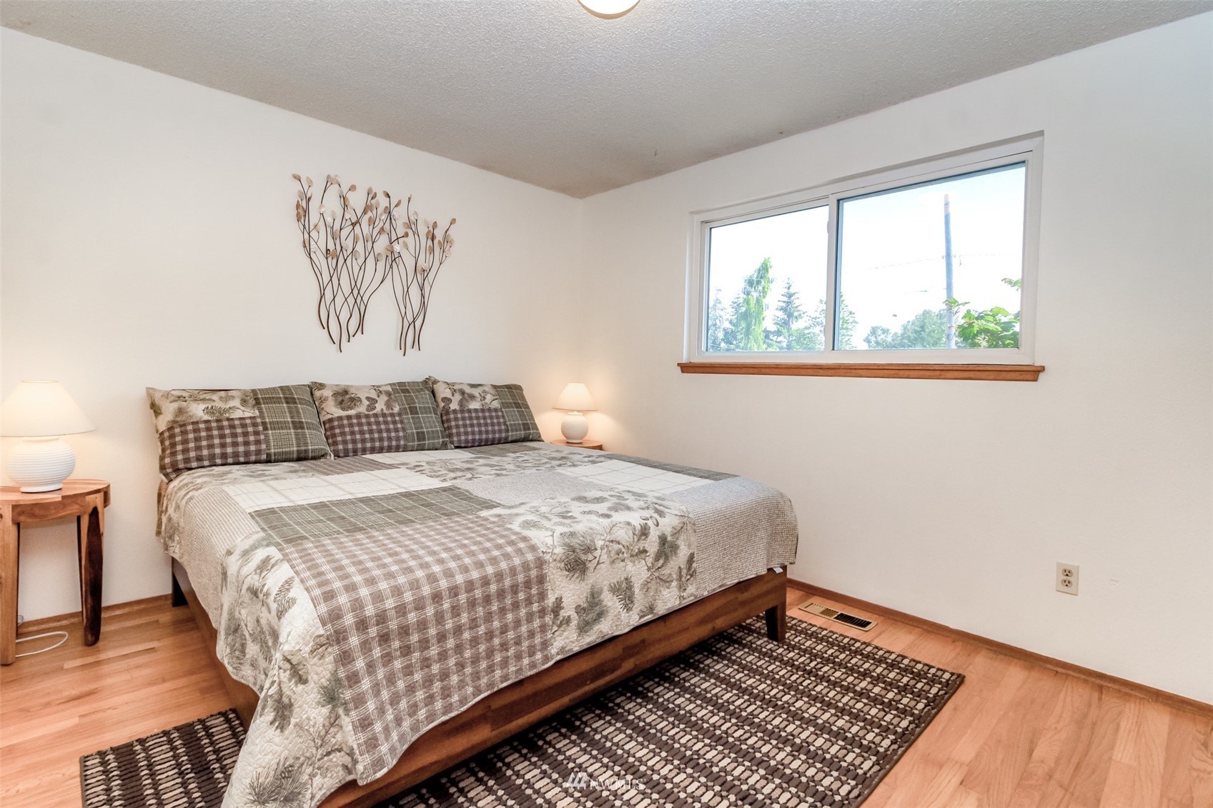 12011 Southeast 157th Place Renton, WA 98058 - Photo 35 of 40 a bedroom with a bed and wooden floor