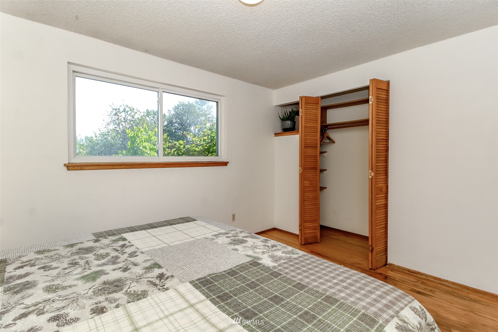 12011 Southeast 157th Place Renton, WA 98058 - Photo 36 of 40 a view of a bedroom with wooden floor and bedroom