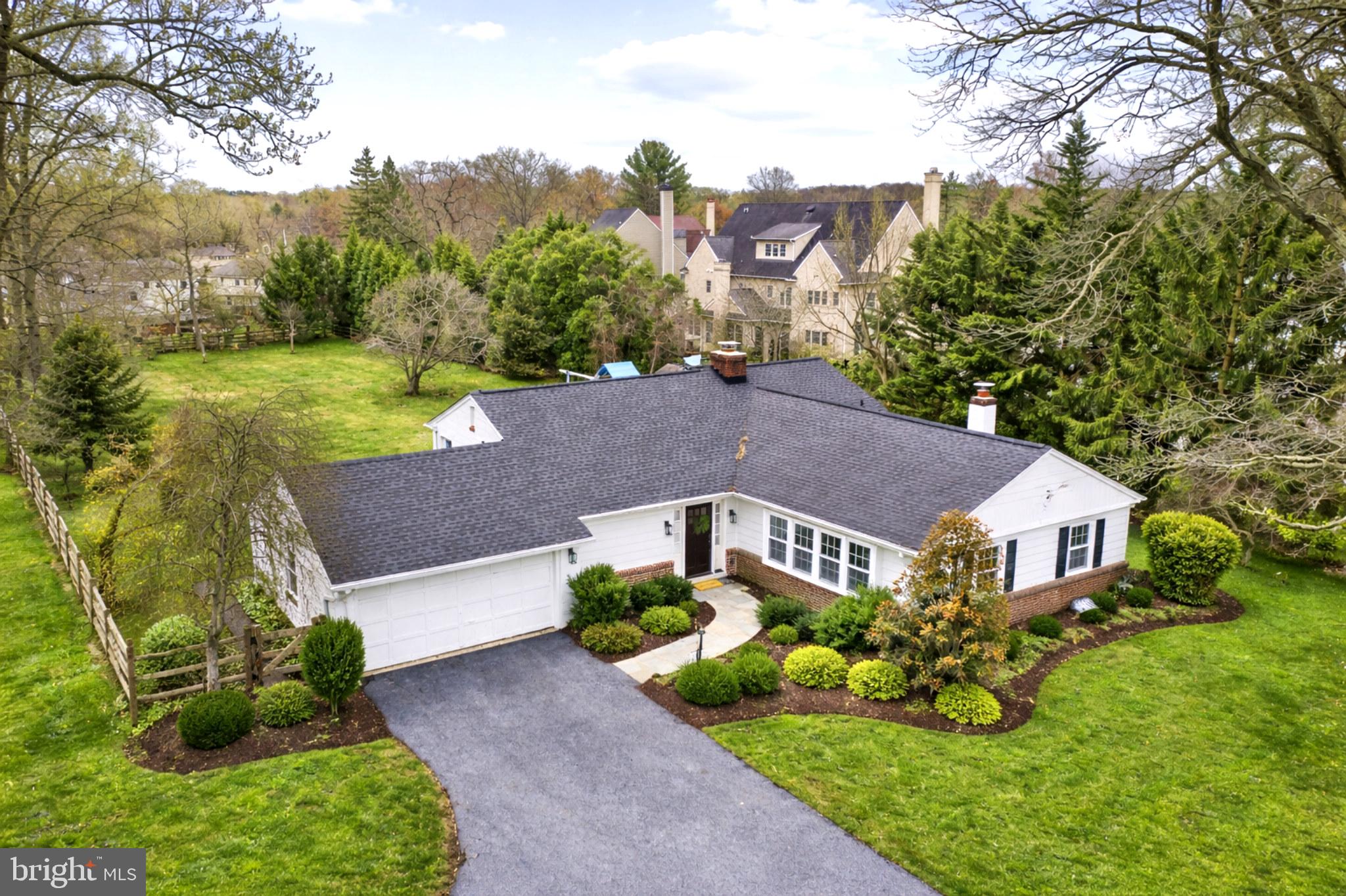 a aerial view of a house next to a yard