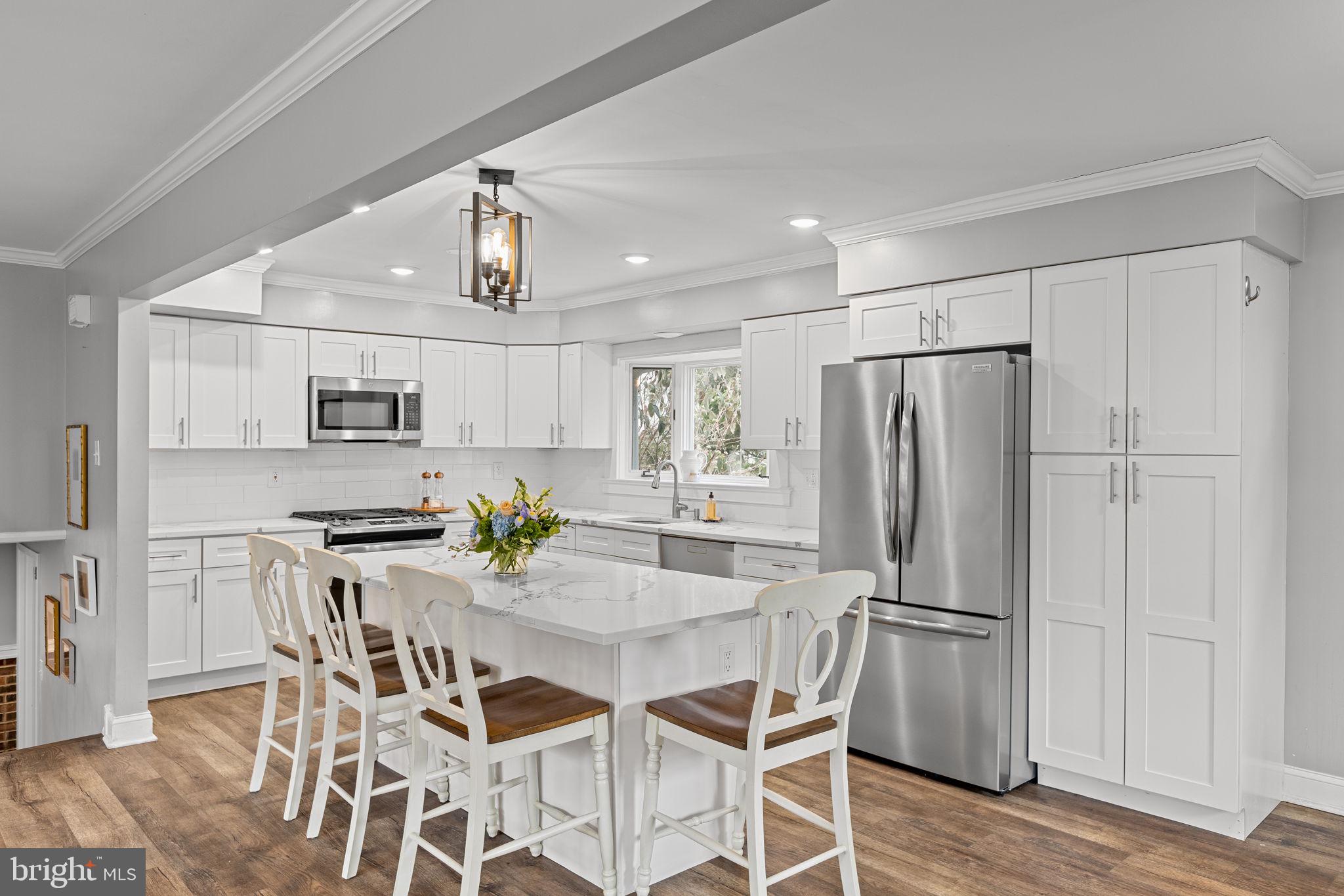 237 Waterloo Avenue Berwyn, PA 19312 - Photo 13 of 58 a kitchen with stainless steel appliances a refrigerator a stove a dining table and chairs