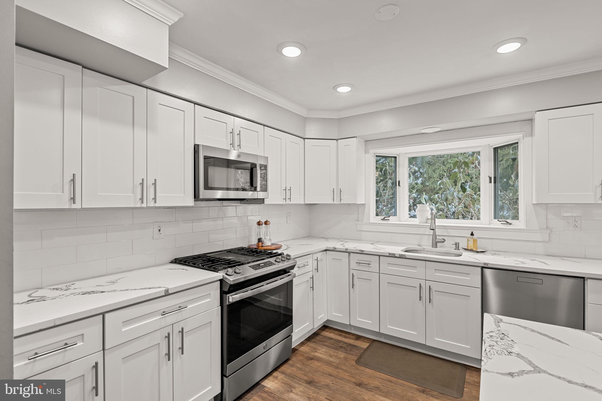 237 Waterloo Avenue Berwyn, PA 19312 - Photo 17 of 58 a kitchen with sink a microwave and cabinets
