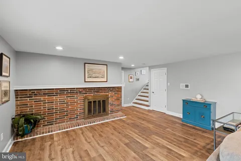 a living room with furniture wooden floor and a flat screen tv