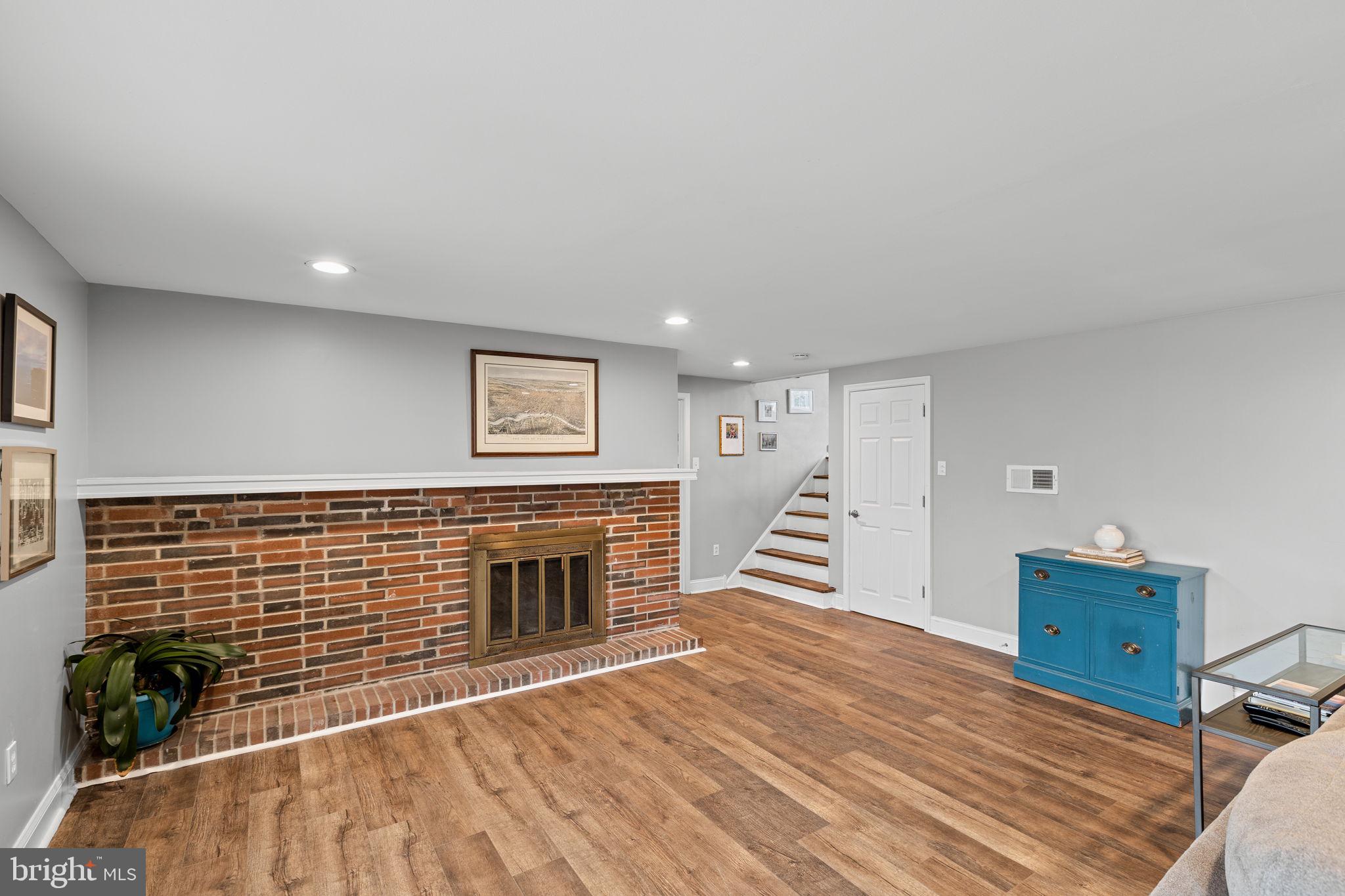 237 Waterloo Avenue Berwyn, PA 19312 - Photo 19 of 58 a view of an empty room with wooden floor and a fireplace