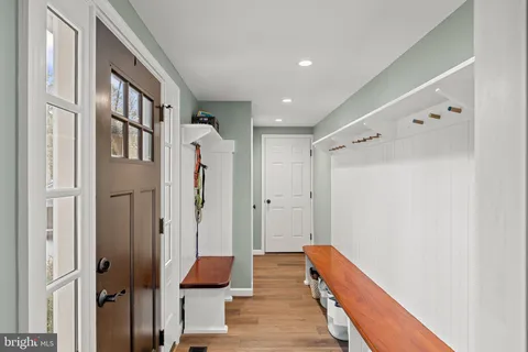 a hallway with furniture and wooden floor