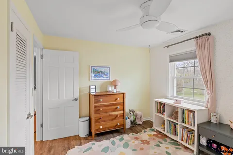 a view of a room with wooden floor and furniture