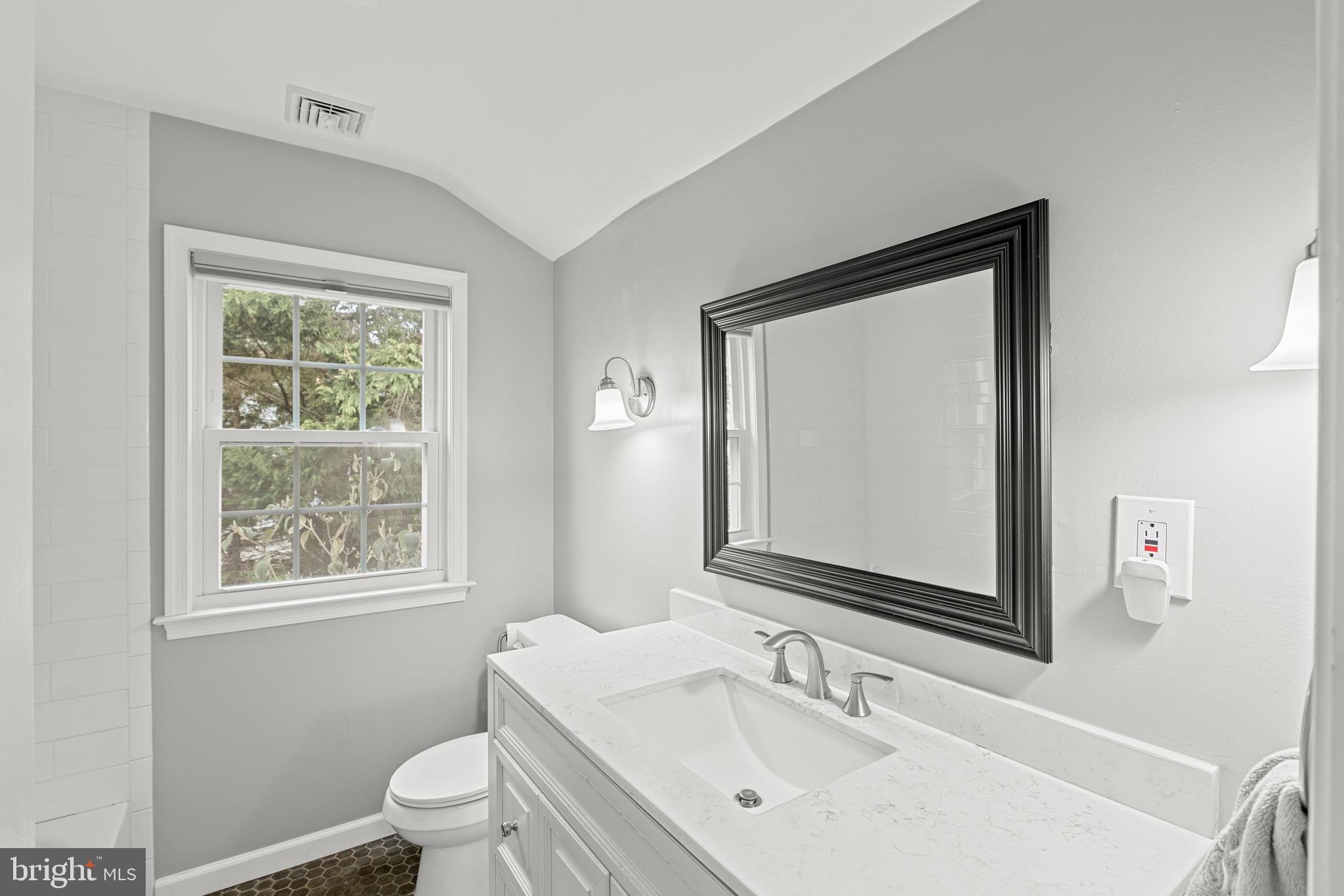 237 Waterloo Avenue Berwyn, PA 19312 - Photo 44 of 58 a bathroom with a toilet a sink a window and mirror