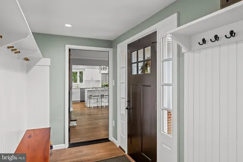 a view of entryway and hall with wooden floor